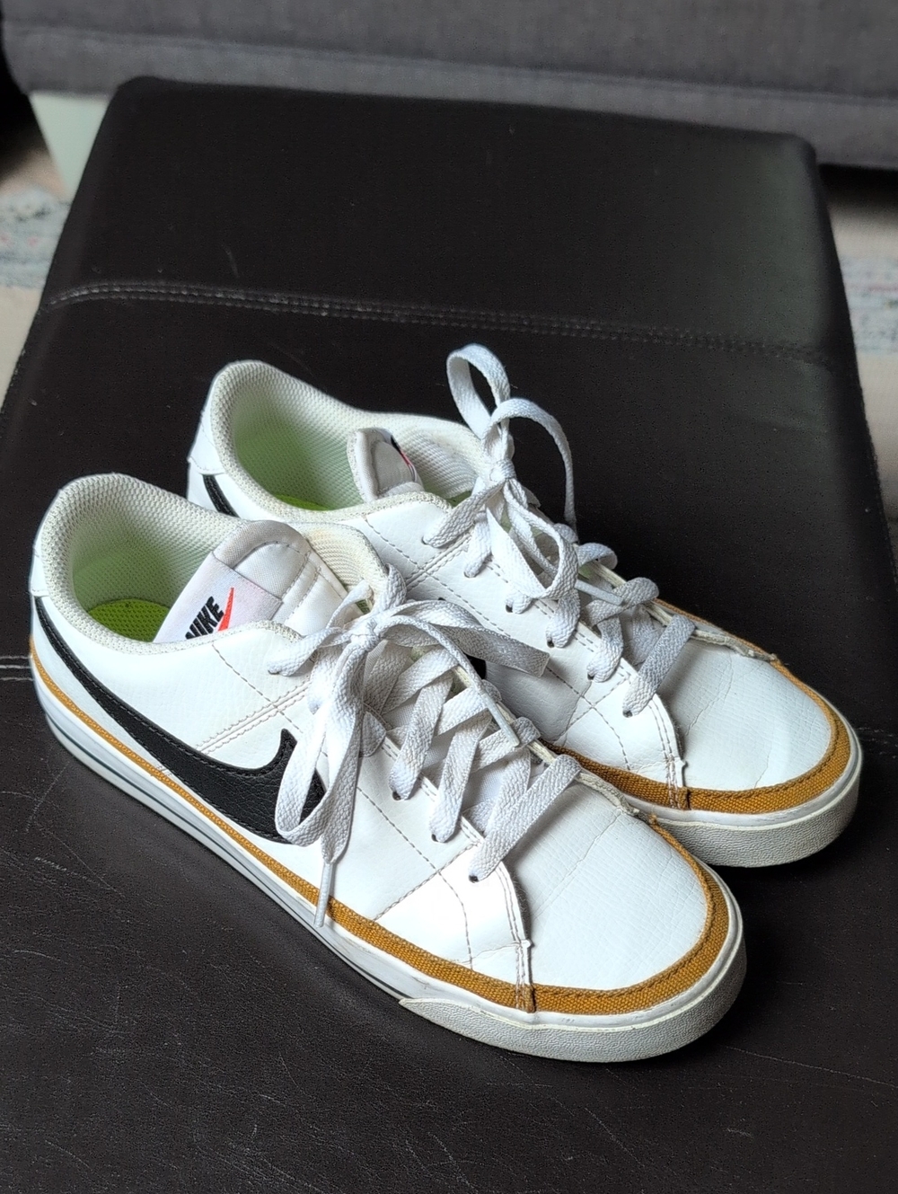 Nike Women’s White Sneakers with Black Swoosh and Gold Trim